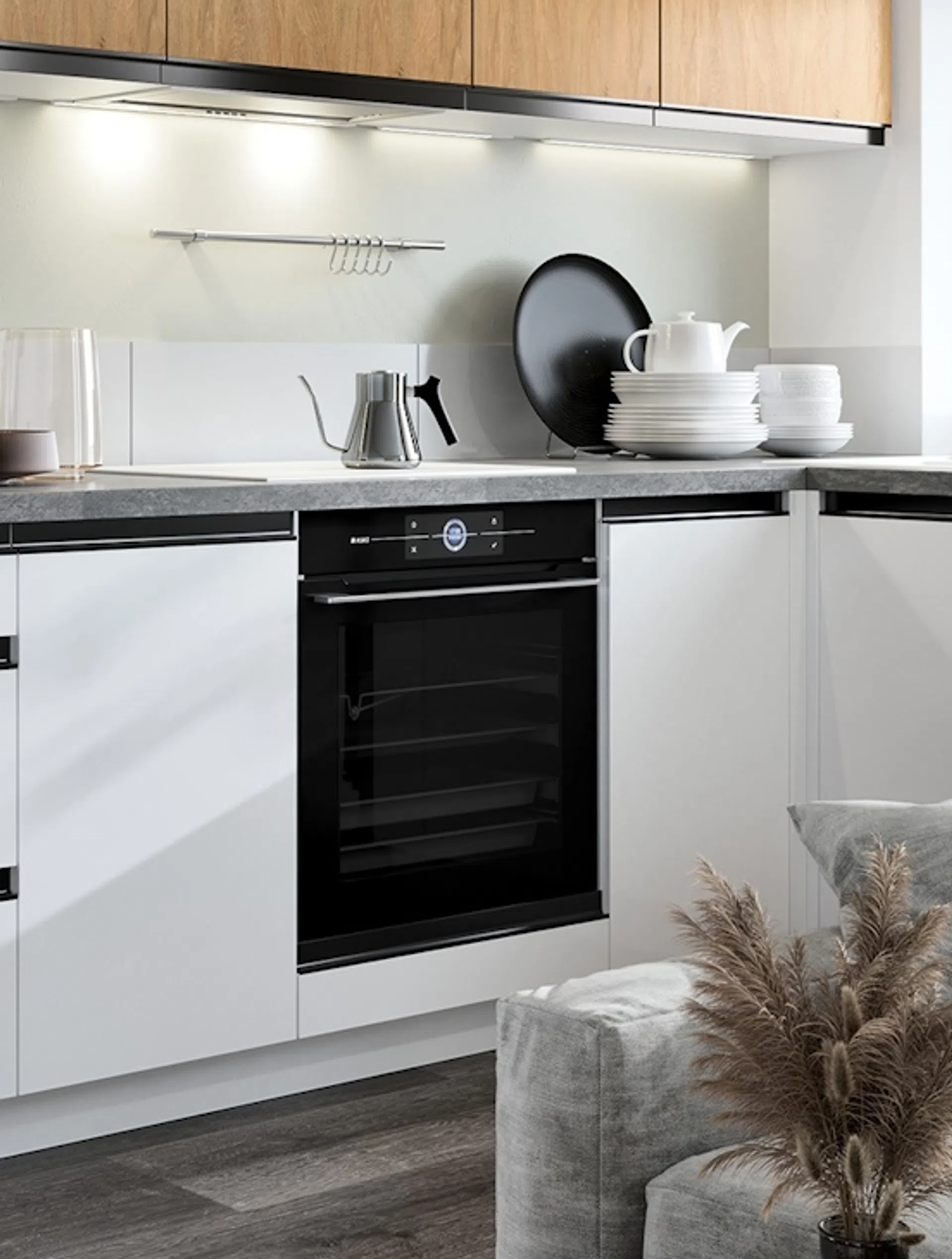 Biała kuchnia z szarym blatem i czarnym AGD